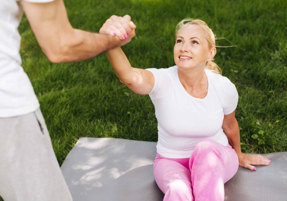 Close-up-man-helping-woman-get-up-scaled