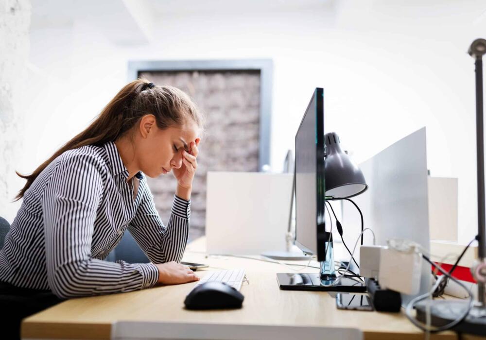 Overworked-and-frustrated-young-woman-in-front-of-kj796sy-scaled