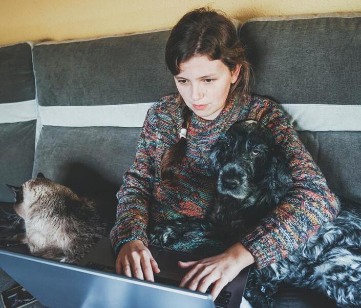 Woman at home on laptop during online /telehealth psychologist appointment
