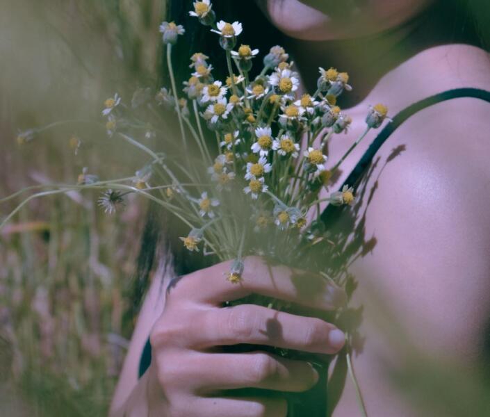 Woman holding wild flowers